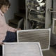 woman changing HVAC filters